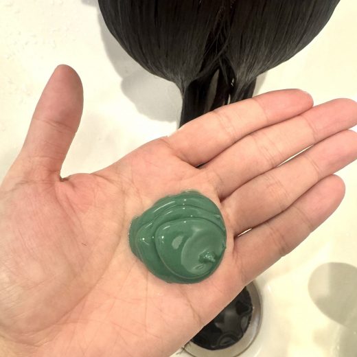 新処方の緑色のクリームを手のひらに乗せた写真。pH調整・内部結合強化・残留物除去などの新成分を含むトステア進化版の要素。